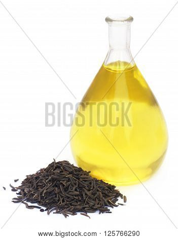 Caraway seeds with essential oil in glass jar