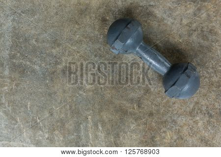 metal dumbbell on cement floor fitness sport of bodybuilding background