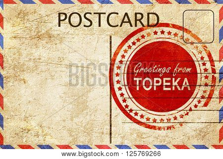 greetings from topeka, stamped on a postcard