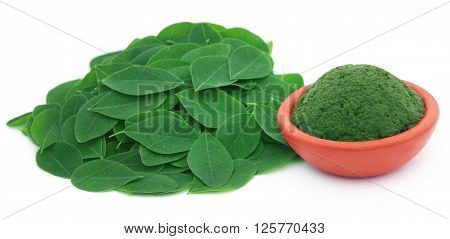 Edible moringa leaves with ground paste in a pottery