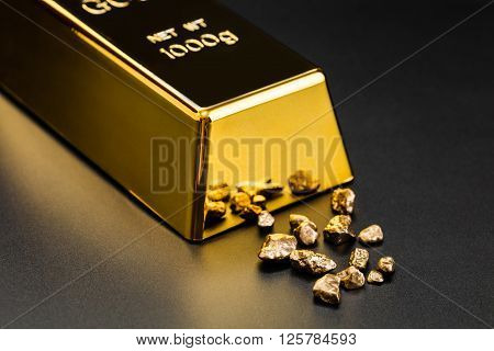 gold bullion and nuggets on a dark background