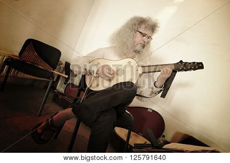 HUNEDOARA, ROMANIA - AUGUST 13, 2015: acoustic guitar player in medieval Corvin Castle of Hunedoara
