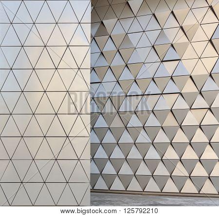 Abstract close-up view of modern aluminum ventilated facade of triangles