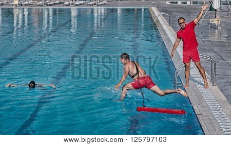 Lifeguard training course - rescuing victim from swimming pool