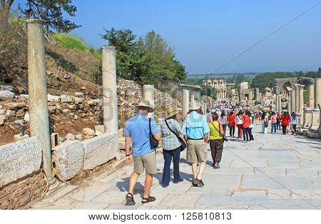 EPHESUS, TURKEY - APRIL 30, 2012: Tourists in Ephesus, Turkey. Ephesus was an ancient Greek city on the coast of Ionia three kilometres southwest of present-day Selcuk in Izmir Province, Turkey