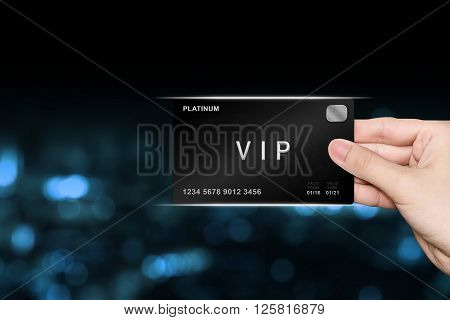 hand picking VIP or very important person platinum card on blur background
