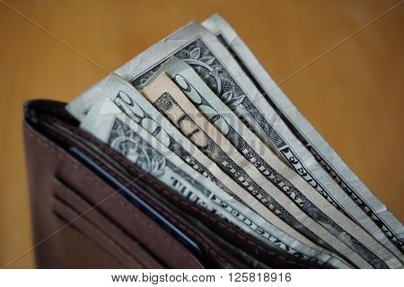 Male hand holding a leather wallet and withdrawing American currency (USD, US Dollars)
** Note: Soft Focus at 100%, best at smaller sizes