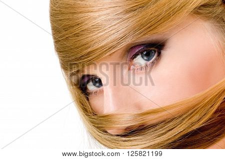 Beautiful blye eyes of woman with long blond hair around, watching in camera, isolated over white