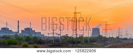 Power Plant at sunset with cloudy sky.