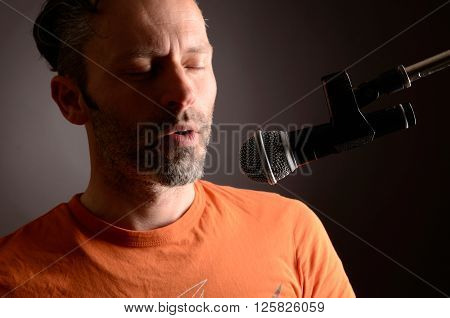 A man with a microphone in a studio