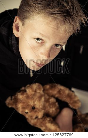 Sad Little Boy Holding Plush Bear Toy