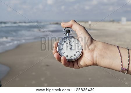 Time in My Hand Stopwatch in hand on seashore
