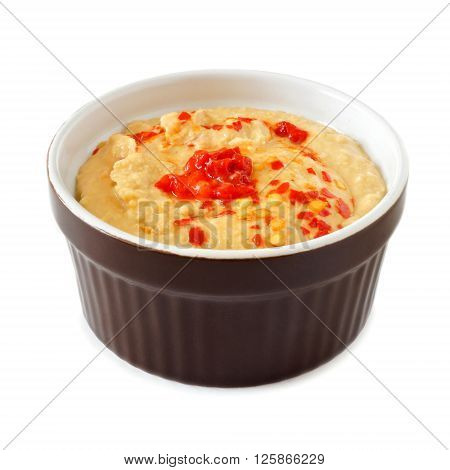 Spicy Hummus Dip A With Hot Peppers In A Ramekin Bowl Isolated On A White Background