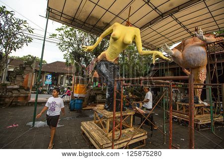 UBUD, INDONESIA - MAR 5, 2016: Unidentified local people during built Ogoh-ogoh are statues for the Ngrupuk parade, which takes place on the eve of Nyepi day. Nyepi is a public holiday in Indonesia.