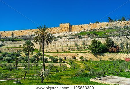 The view on the high ramparts and walled Golden Gate with the Muslim Cemetery in front of it from the Kidron Valley Jerusalem Israel.