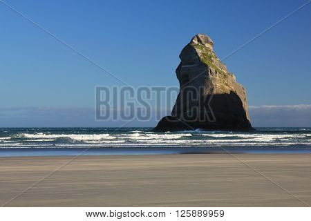 Island at Wharariki Beach. Morning scene at the West Coast of the South Island. Landscape in New Zealand. Nature background.