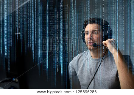 technology, gaming, entertainment, let's play and people concept - young man in headset with pc computer playing game at home and streaming playthrough or walkthrough video