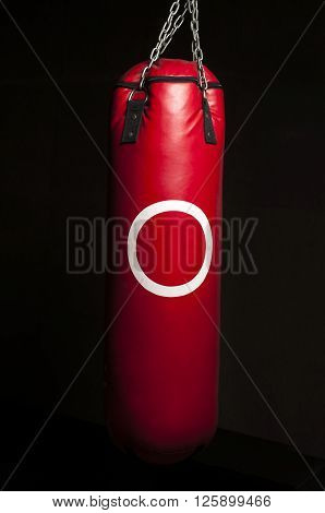 Boxing series : Red punching bag on black background