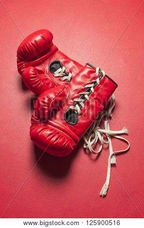 Boxing series : Red boxing gloves on red leather background