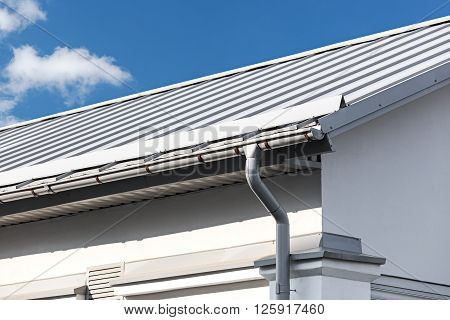 Gray Metal Roof With Gutter And Drainpipe