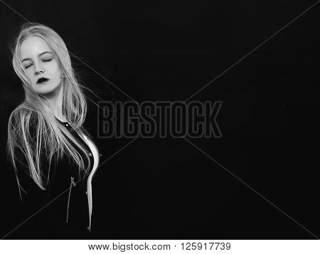 sensual blond girl on black background monochrome image with copyspace