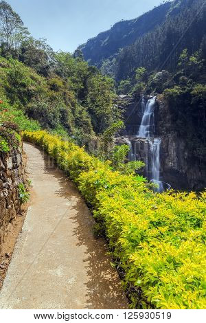 The road to the beautiful waterfalls Ramboda in sunny weather, the island of Sri Lanka. Falls - one of the symbols in Sri Lanka