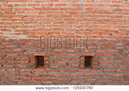 Brick wall placed on a vertical stick with a plaster waiting to shetland.