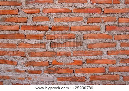 Brick wall placed on a vertical stick with a plaster waiting to shetland.