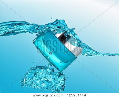 The blue jar of moisturizing cream in the blue water wave  with  air bubbles and water drops on the blue water background
