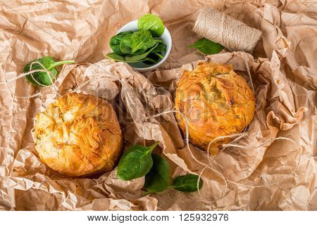 Spanakopita - Greek spinach pie with feta and ricotta street food on wrapping paper