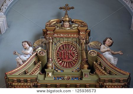 ZAGREB, CROATIA - SEPTEMBER 14: IHS sign on the altar in the Basilica of the Sacred Heart of Jesus in Zagreb, Croatia on September 14, 2015
