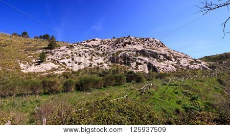 View of the Necropolis of Realmese. Necropoli Pantalicana is an achaeological park in Calascibetta Sicily