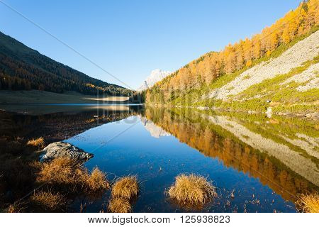 Mountain panorama from Italian Alps. Reflections on water from 