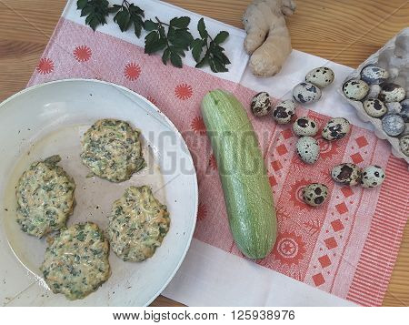 Cooking squash goutweed fritters with ginger and quail eggs, pancakes with wild plant