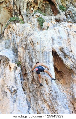 Man climbing in rock sea Krabi in Thailand