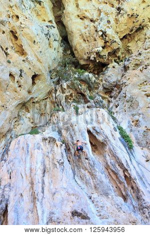 Man climbing in rock sea Krabi in Thailand