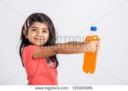 indian girl with cold drink bottle, asian girl drinking cold drink in pet bottle, girl kid and cold drink, indian cute girl with mango or orange cold drink in plastic bottle, isolated