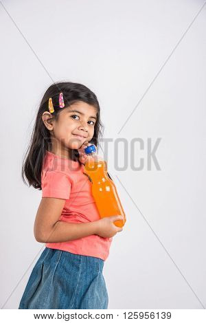 indian girl with cold drink bottle, asian girl drinking cold drink in pet bottle, girl kid and cold drink, indian cute girl with mango or orange cold drink in plastic bottle, isolated