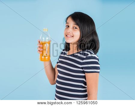 indian girl with cold drink bottle, asian girl drinking cold drink in pet bottle, girl kid and cold drink, indian cute girl drinking mango juice or orange juice in plastic bottle