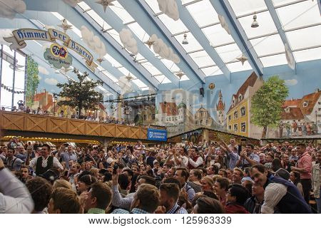 MUNICH, GERMANY - OCTOBER 02, 2015: Inside the Hacker Festzelt (Himmel der Bayern) at Oktoberfest with its lovely decoration of the roof and the surrounding walls