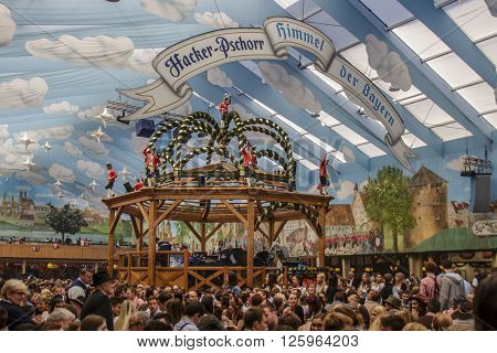MUNICH, GERMANY - OCTOBER 02, 2015: Inside the Hacker Festzelt (Himmel der Bayern) at Oktoberfest with its lovely decoration of the roof and the surrounding walls