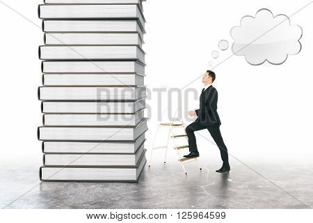 Education concept of businessman with speech bubble climbing book stack
