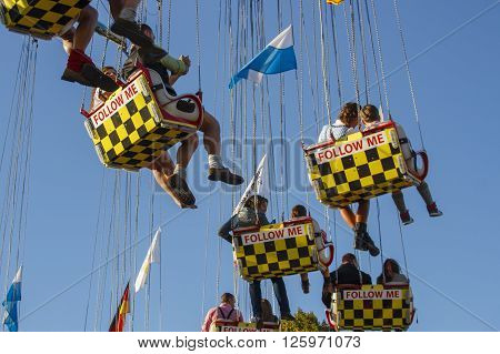 MUNICH, GERMANY - OCTOBER 02, 2015: Carousel in motion with people flying through the air on Theresienwiese