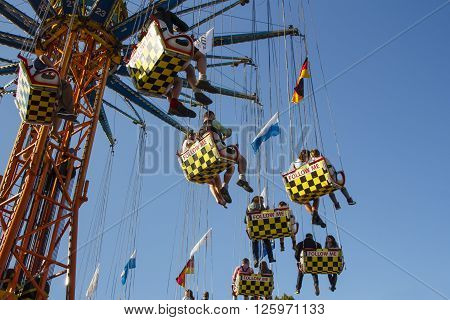 MUNICH, GERMANY - OCTOBER 02, 2015: Carousel in motion with people flying through the air on Theresienwiese