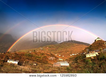 Beautiful rainbow over Zuluk village Sikkim West Bengal India - colourful natural blue sky background
** Note: Visible grain at 100%, best at smaller sizes