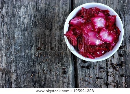 Sauerkraut with beets on a wooden background