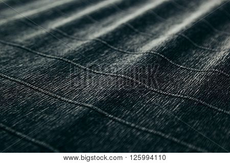 Abstract textured velvety dark background with diagonal lines. The texture.