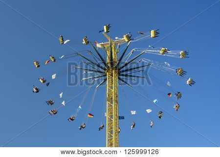 MUNICH, GERMANY - OCTOBER 02, 2015: Carousel in motion with people flying through the air on Theresienwiese