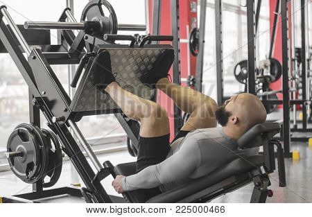 Professional athlete doing leg day routine at gym, preparing for competition