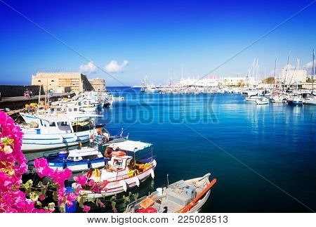 Heraklion old venetian harbour with colorful small fishing boats, yachts and ships, Heraclion Crete, Greecer with flowers